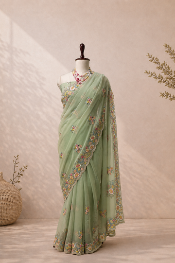 Elegant mint green Vaaari chiffon saree with delicate floral embroidery and handcrafted embellished border.