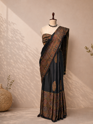 Black Modal Silk Ajrak Saree displayed on mannequin with traditional woven border and elegant ethnic design, perfect for festive and party wear.