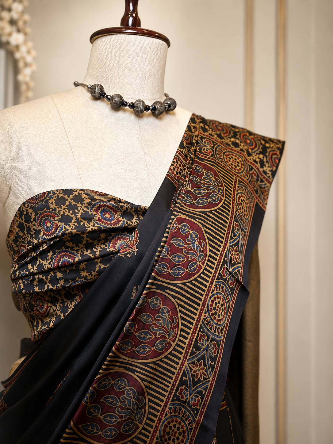 Black Modal Silk Ajrak Saree displayed on mannequin with traditional woven border and elegant ethnic design, perfect for festive and party wear.
