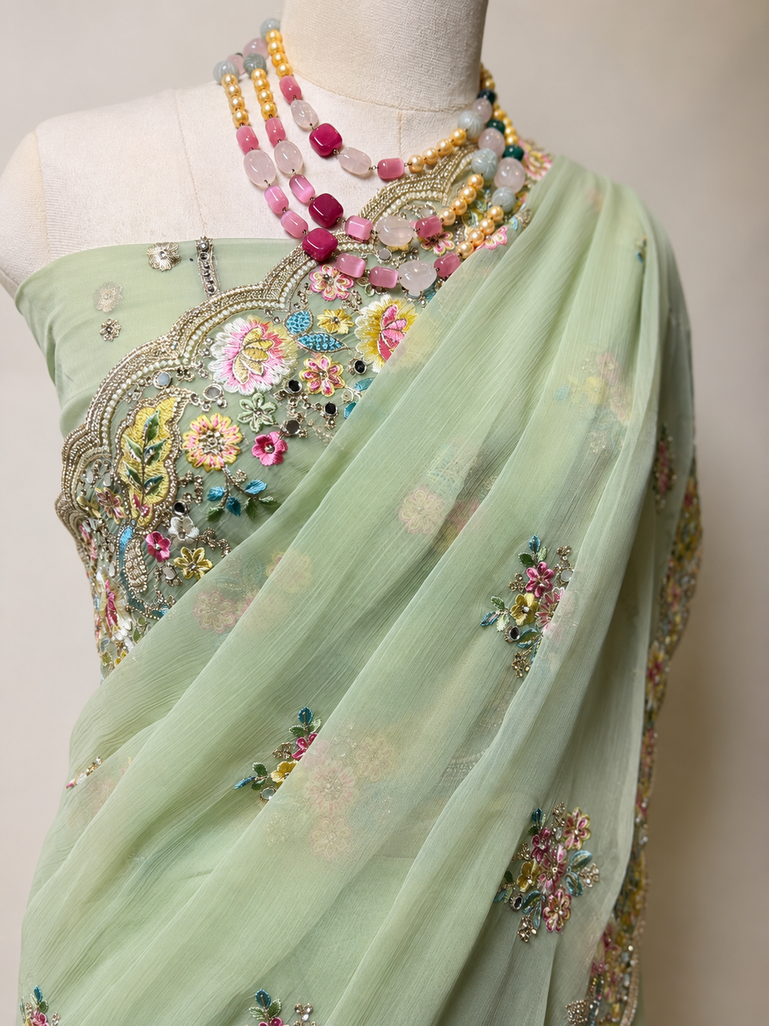 Elegant mint green Vaaari chiffon saree with delicate floral embroidery and handcrafted embellished border.