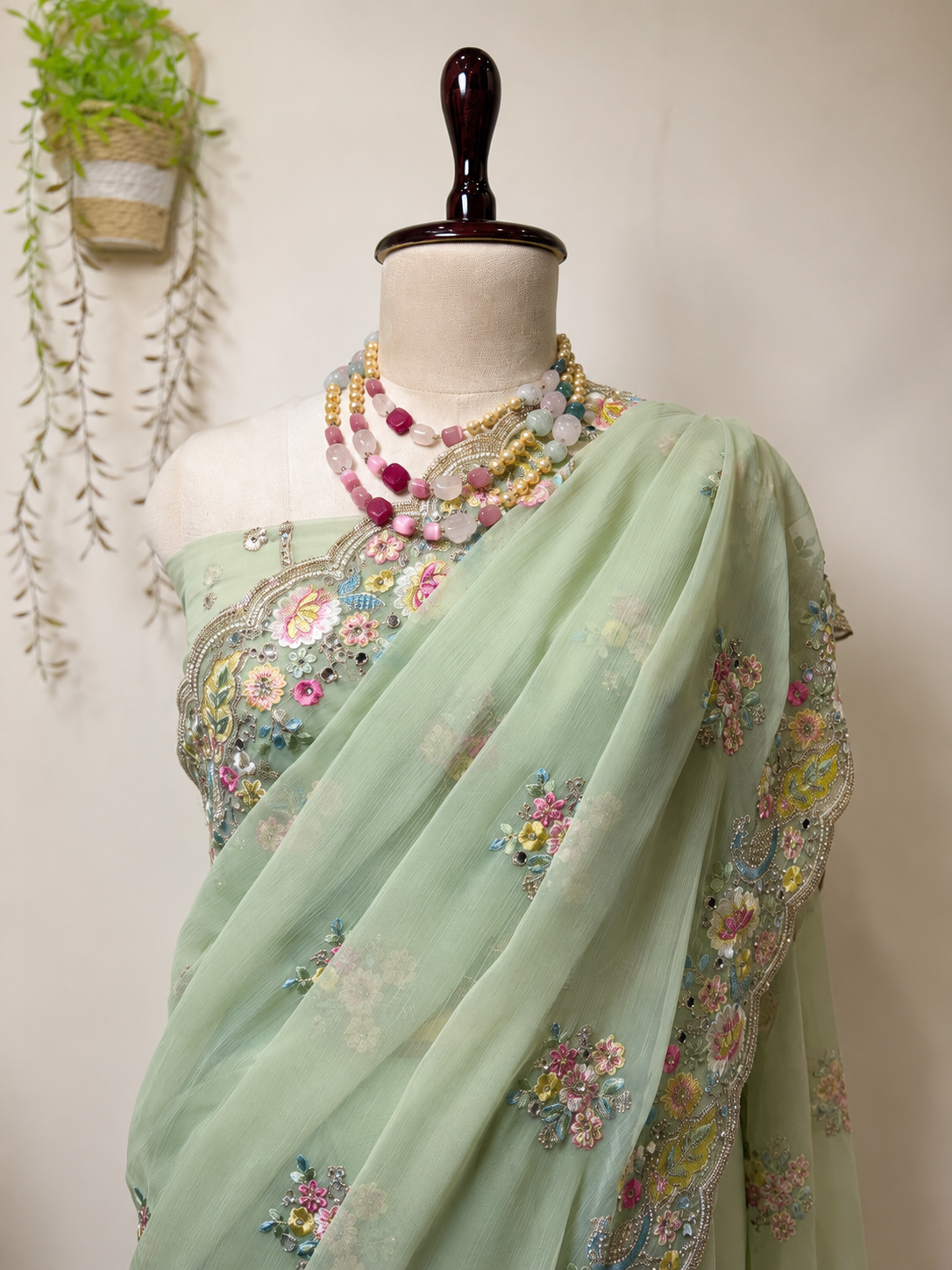 Elegant mint green Vaaari chiffon saree with delicate floral embroidery and handcrafted embellished border.