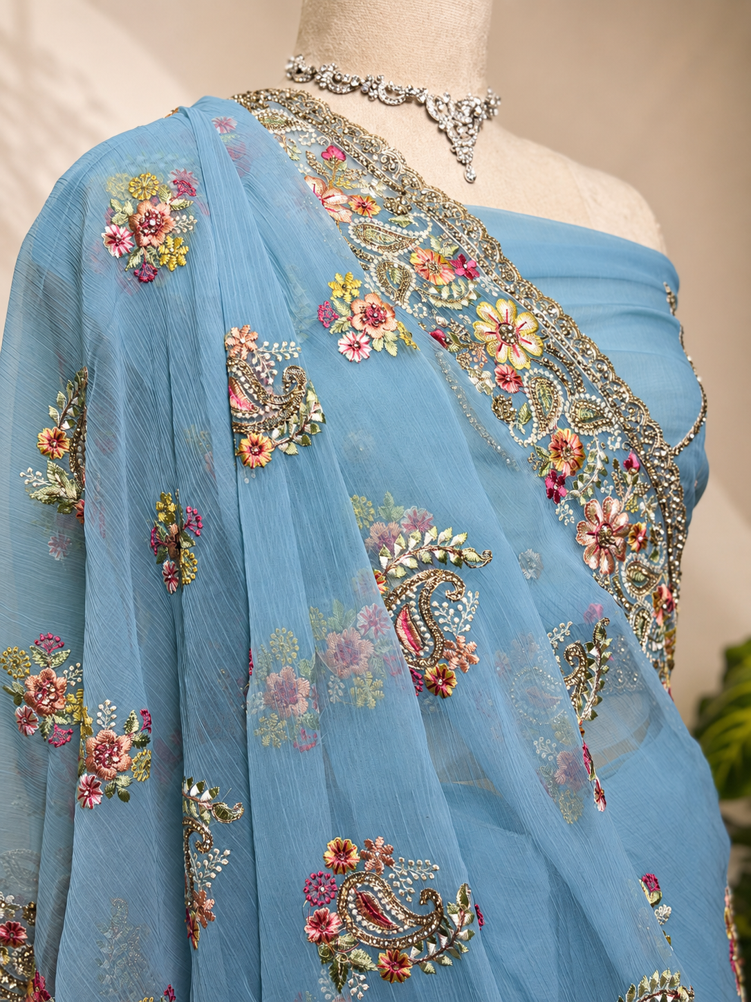 Blue Vaaari chiffon saree with floral embroidery and embellished border.
