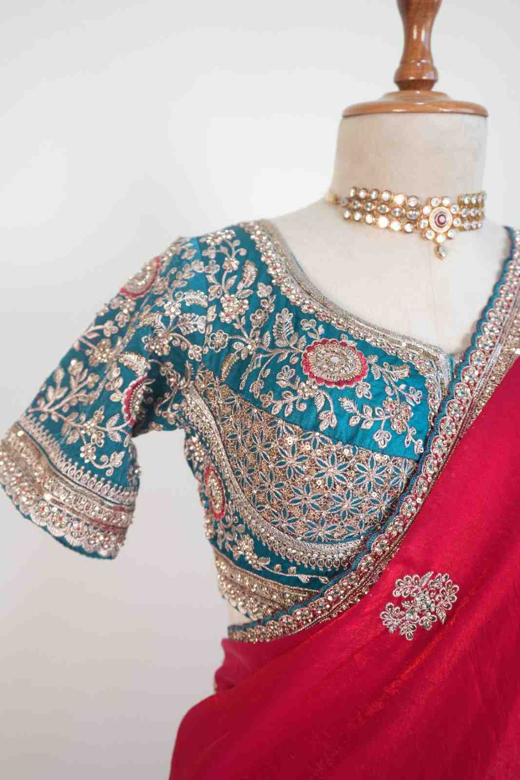 Stitched blouse with red festive saree and embellished border, vibrant wedding and festive party wear saree for women