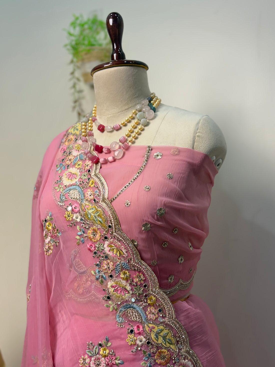 Elegant soft pink Vaaari chiffon saree with floral embroidery and embellished border.
