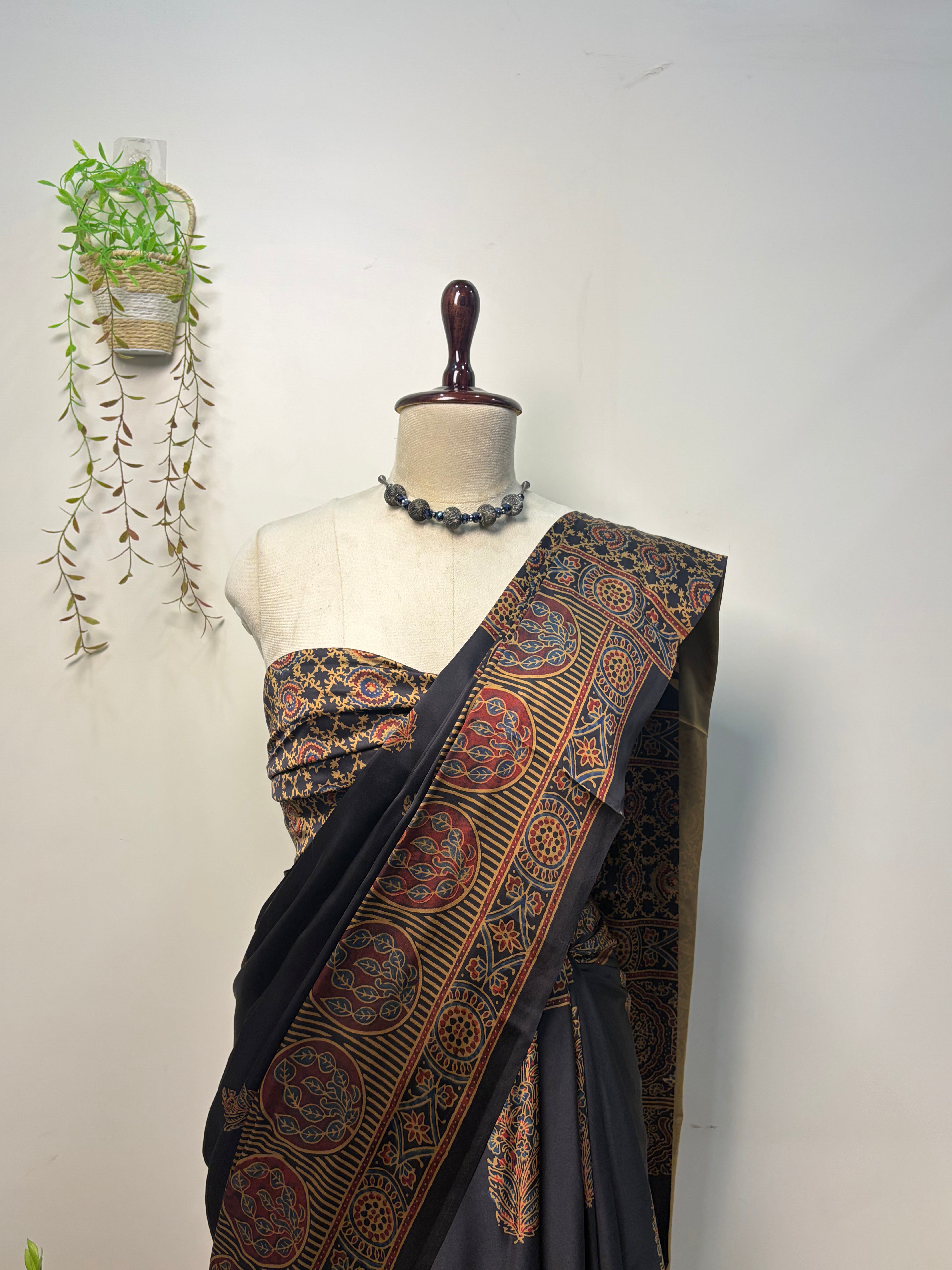 Black Modal Silk Ajrak Saree displayed on mannequin with traditional woven border and elegant ethnic design, perfect for festive and party wear.