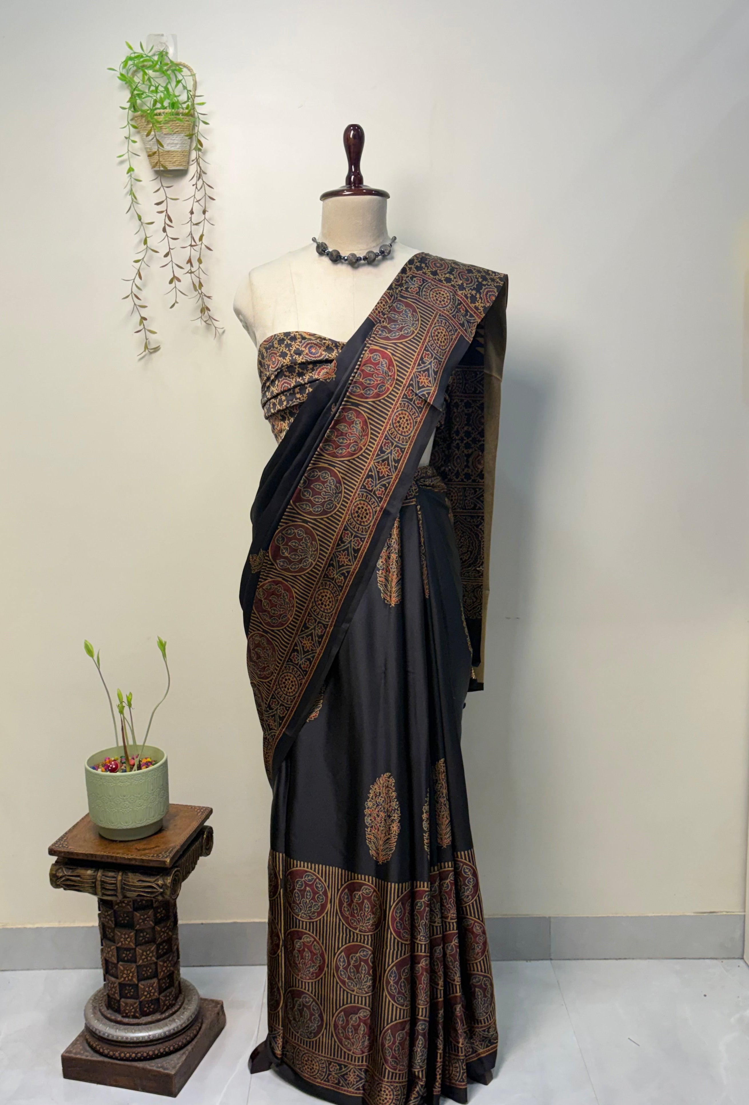Black Modal Silk Ajrak Saree displayed on mannequin with traditional woven border and elegant ethnic design, perfect for festive and party wear.
