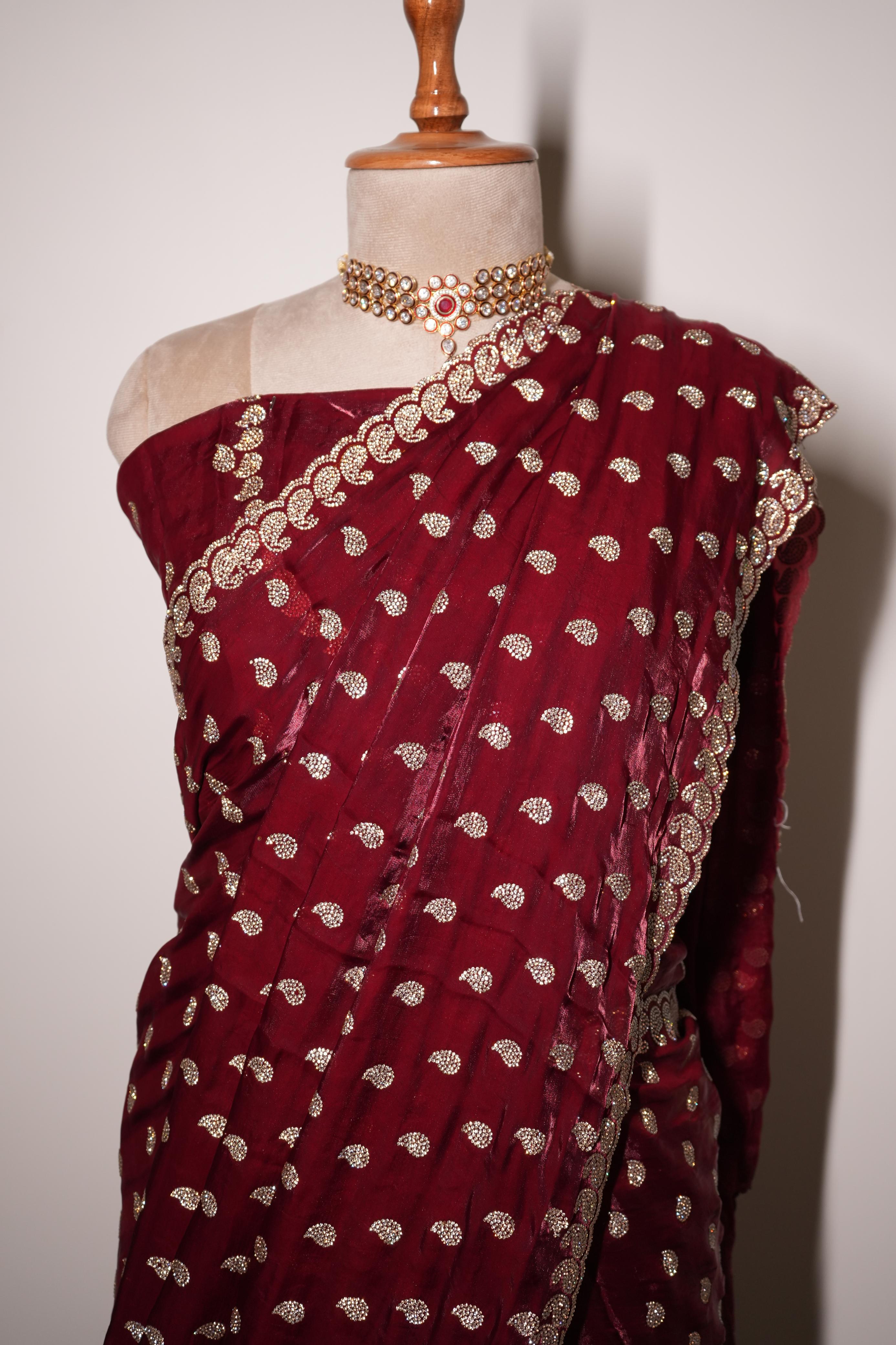 Red designer fendy saree with intricate stone work embroidery and detailed border is ideal for festive and occasion wear.