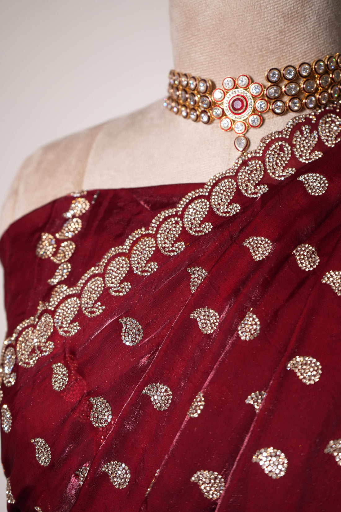 Red designer fendy saree with intricate stone work embroidery and detailed border is ideal for festive and occasion wear.
