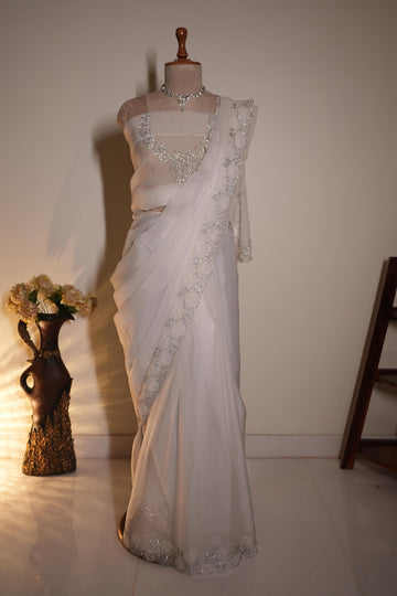 White chiffon saree with intricate stone work and elegant border, perfect for wedding and party wear