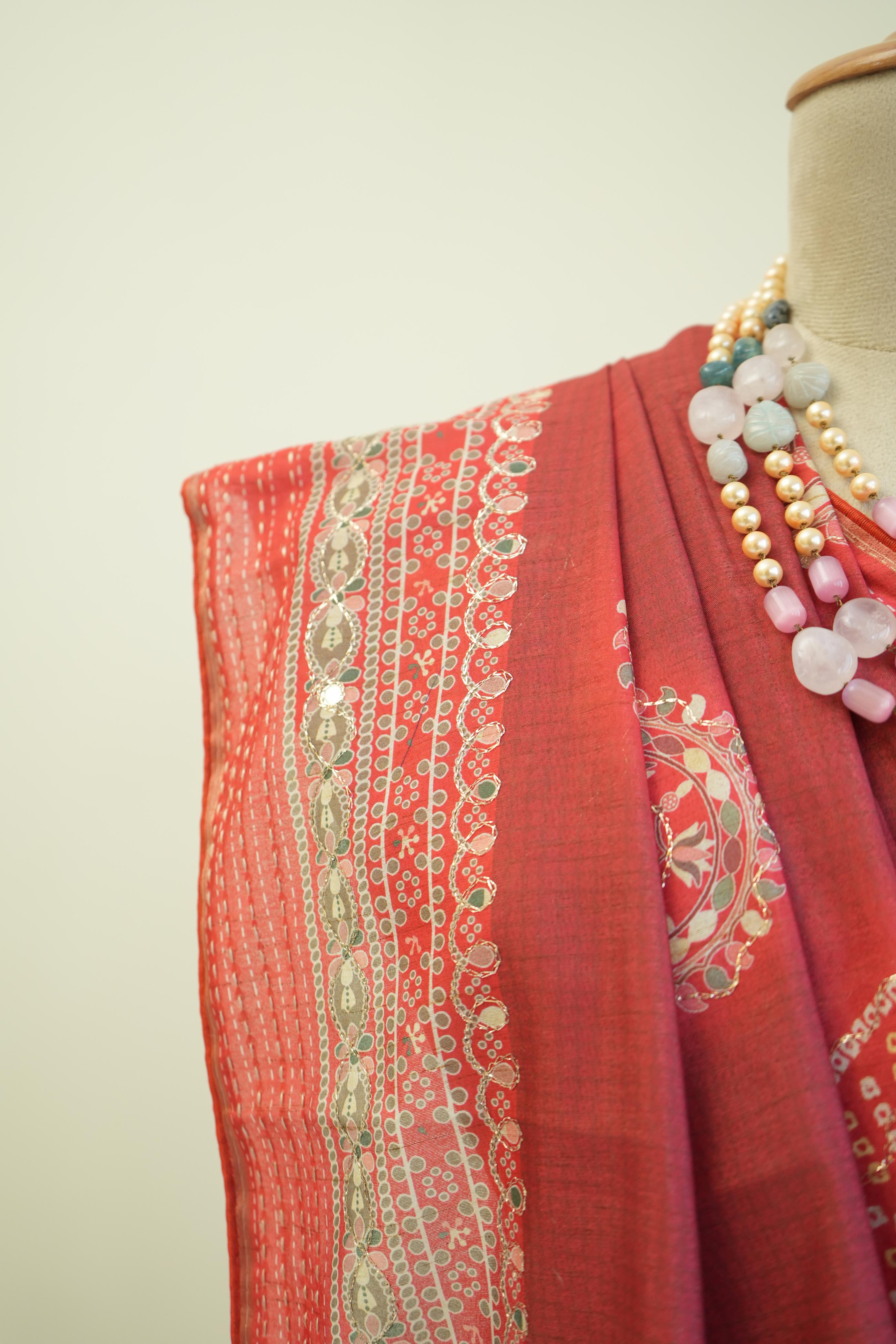 This red cotton saree with printed design and border detailing is a comfortable casual wear saree for women.